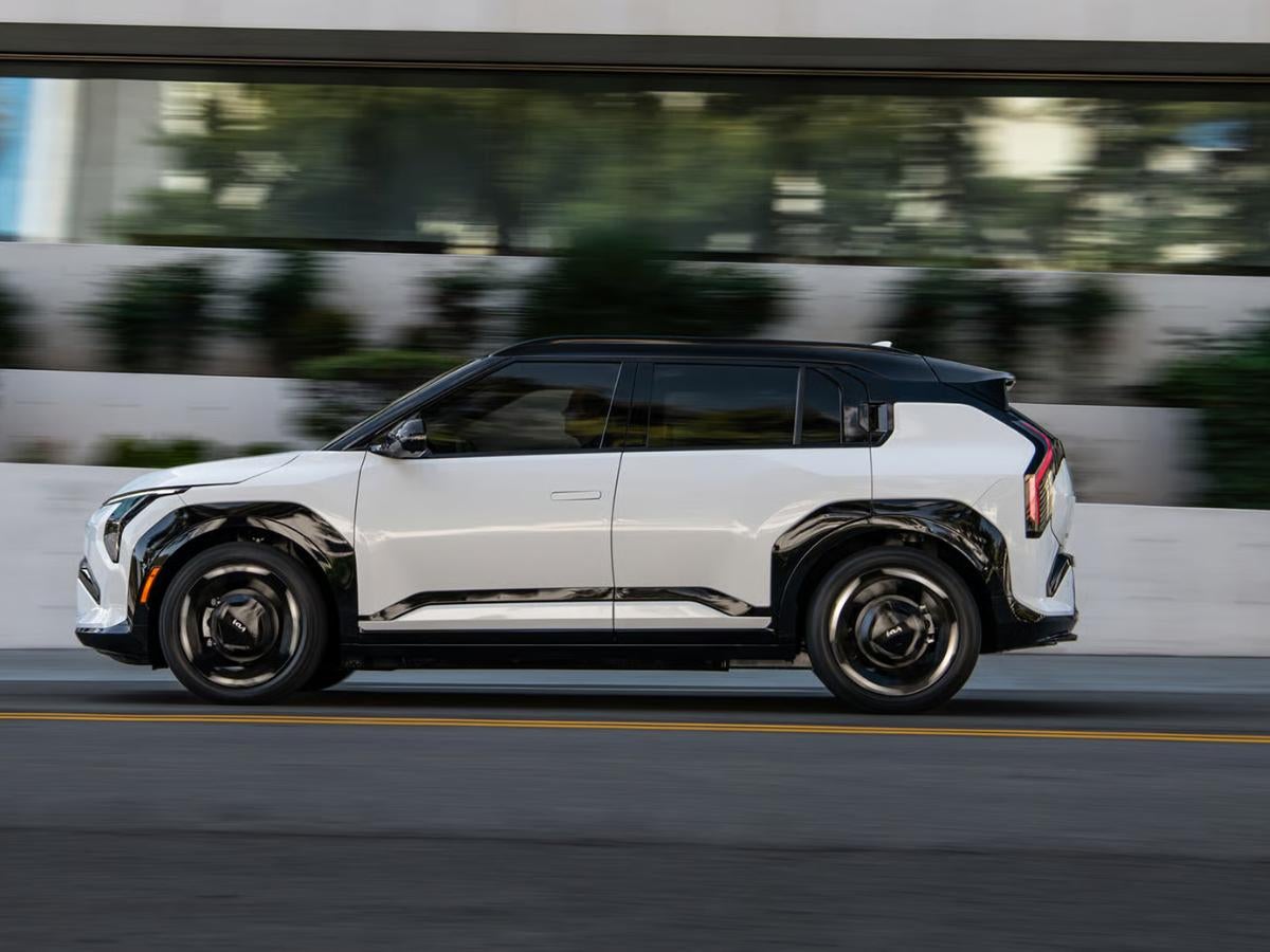 White 2027 Kia EV3 driving on a city street