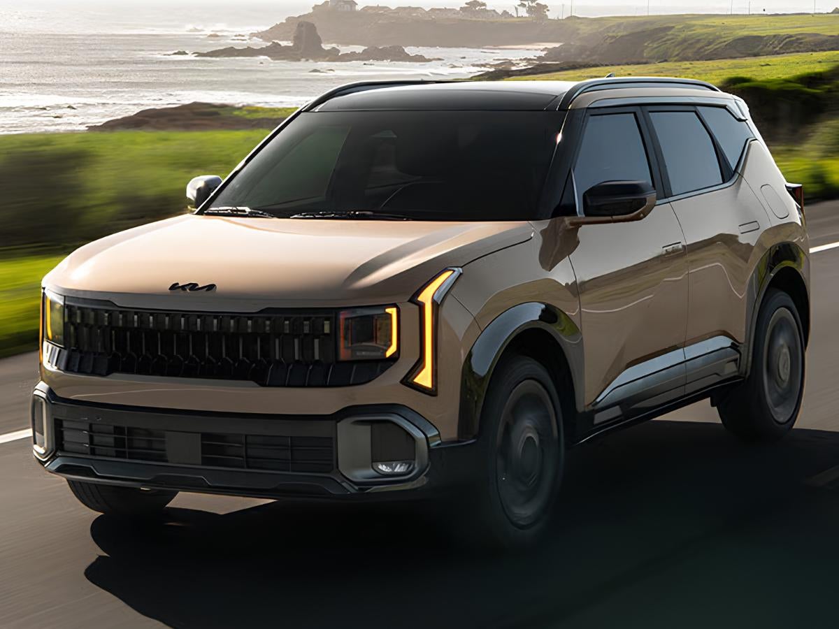 2027 Kia Seltos driving on a coastal highway showcasing Telluride-inspired exterior styling