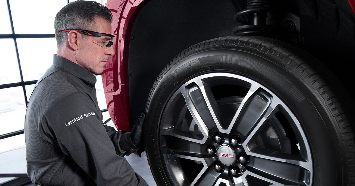 Mechanic installing GMC parts