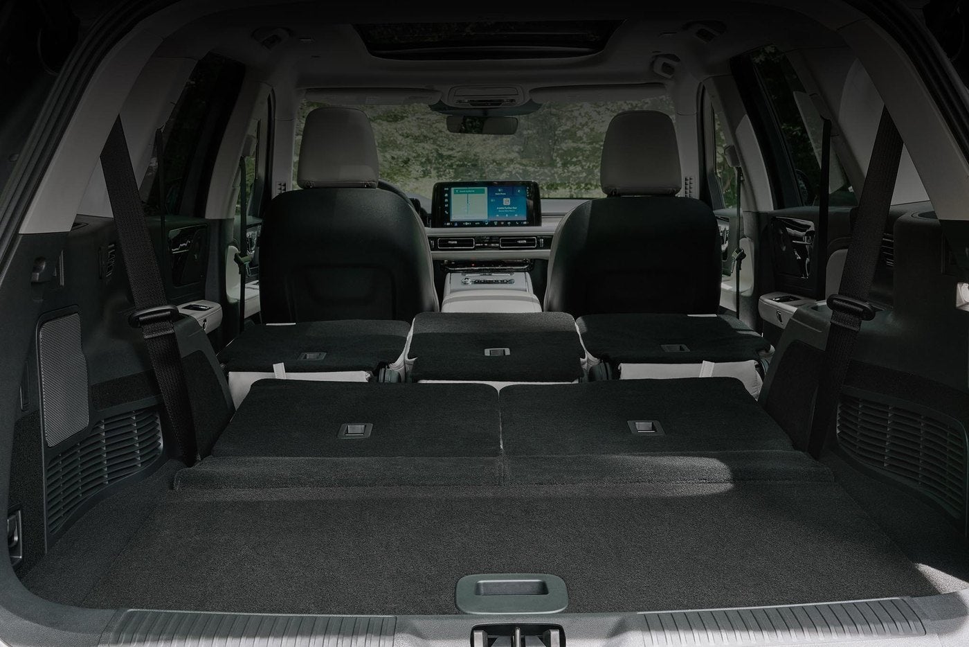 Cargo area of a 2027 Lincoln Aviator with the rear seats folded flat for Manchester MO families