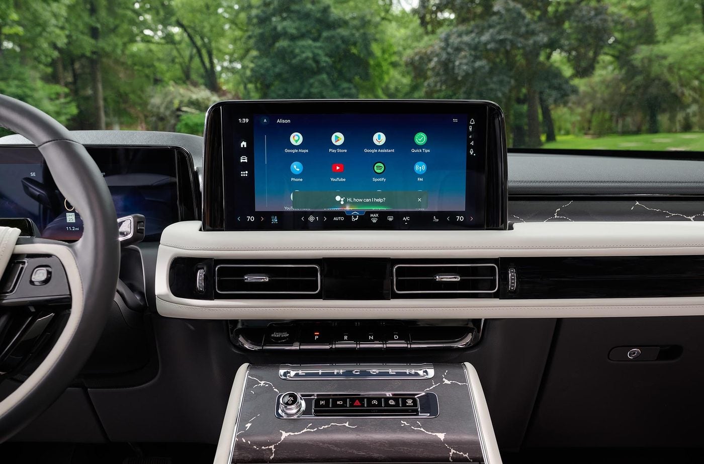 Lincoln Aviator center touchscreen and white trimmed dash with trees outside