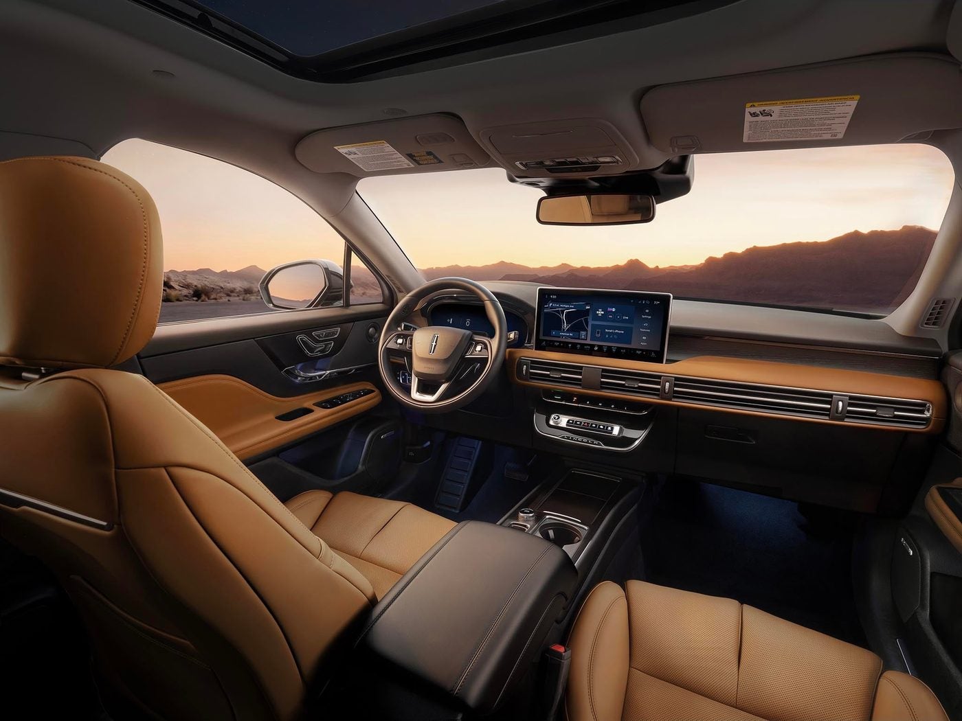 Tan leather front seats, steering wheel and digital display inside a Lincoln Corsair