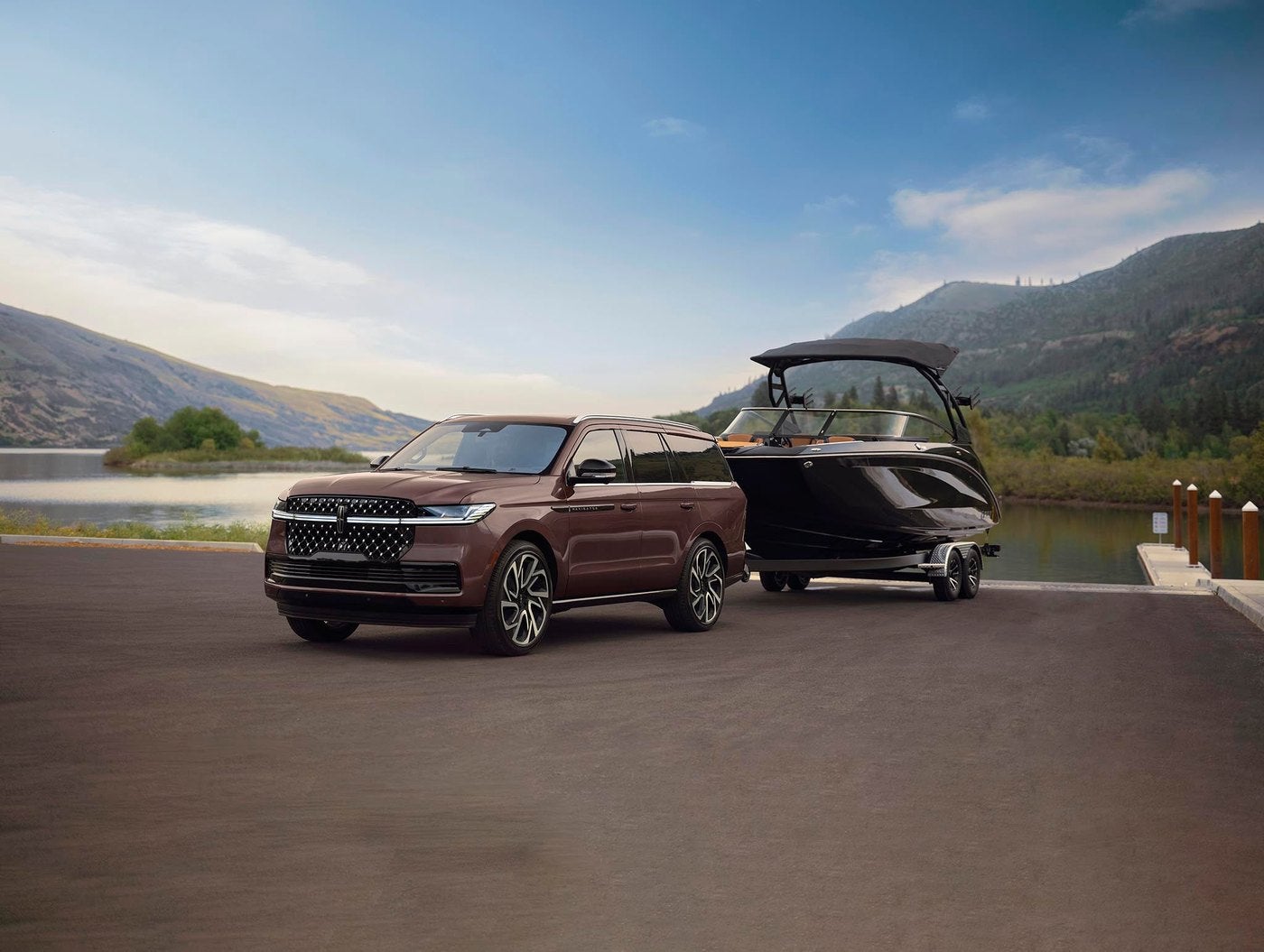2027 Lincoln Navigator with a boat trailer at a lake ramp near Creve Coeur MO