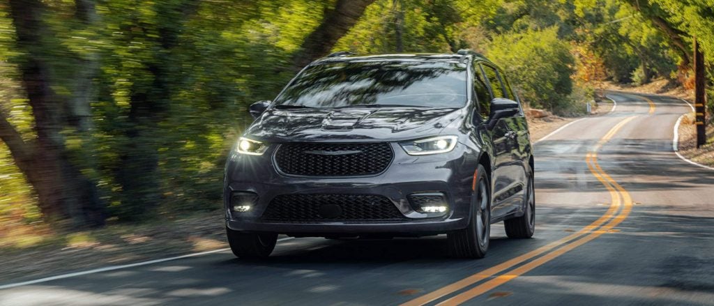A black 2026 Chrysler Pacifica from Gray CDJR, driving on a paved road