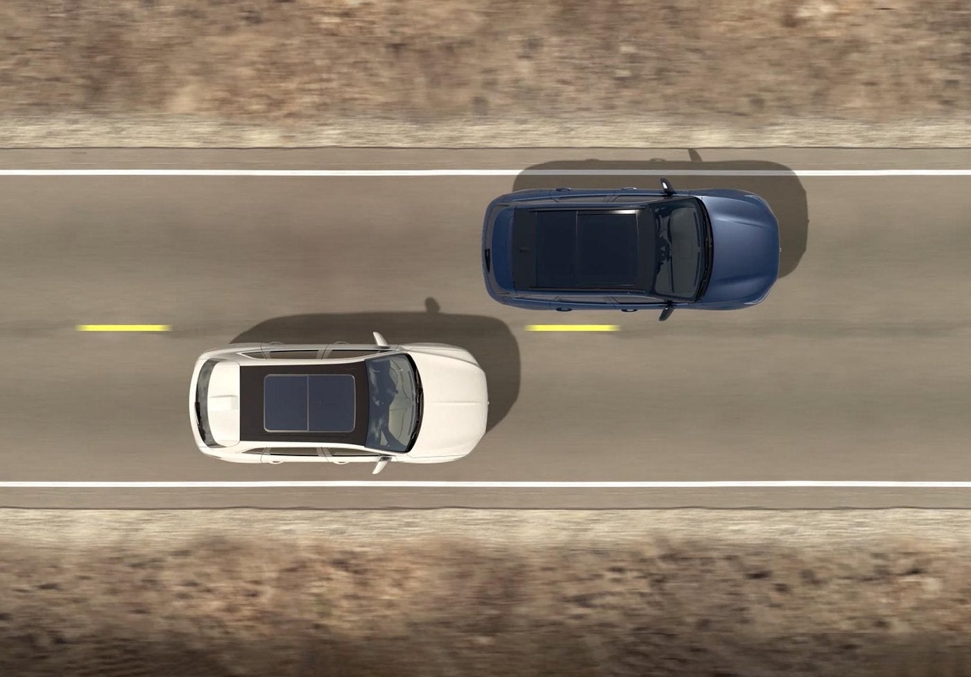 Overhead view of a white Lincoln Aviator passing another SUV on a highway