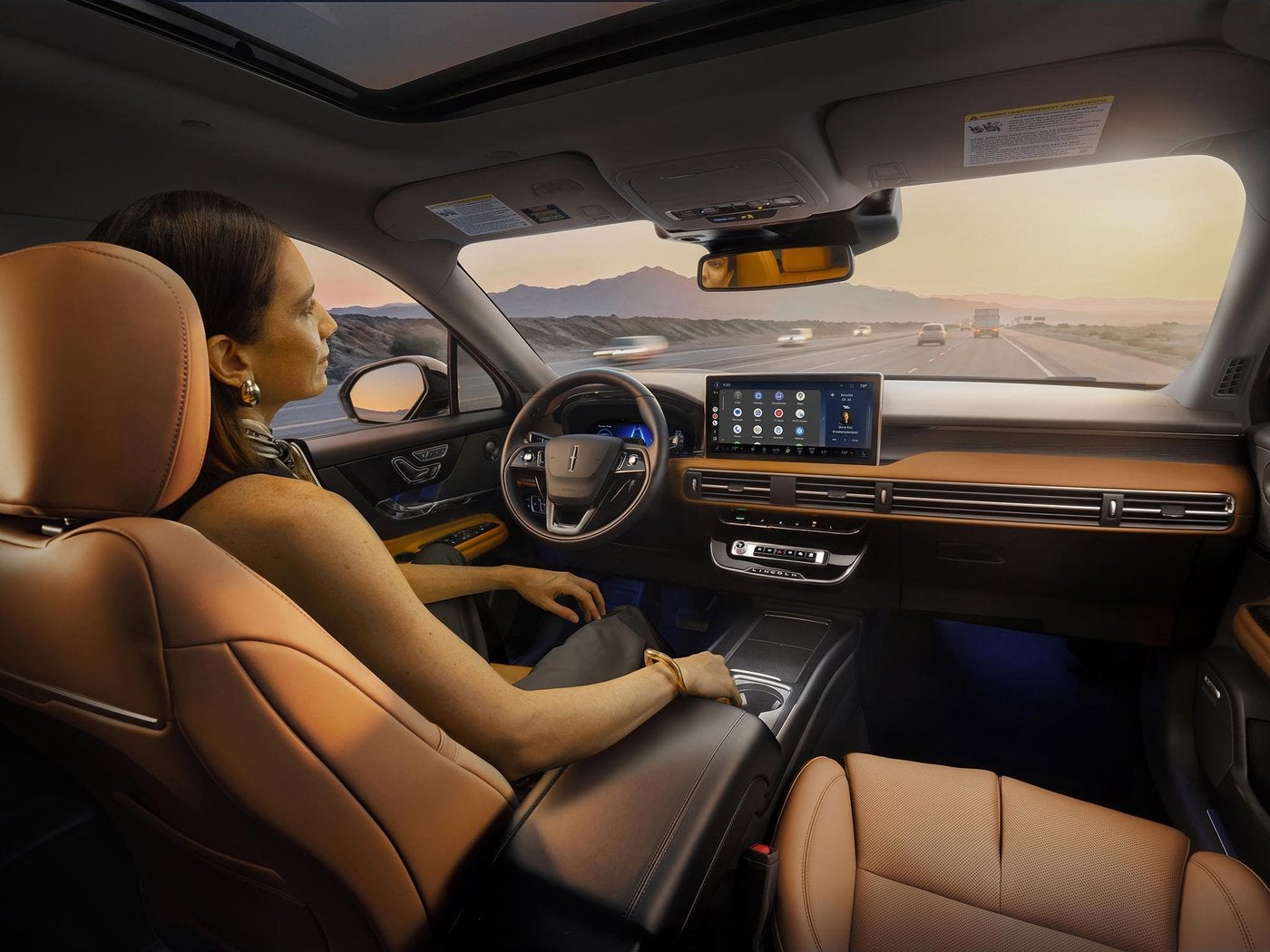 Woman driving a Lincoln Corsair on the highway with the center screen in view
