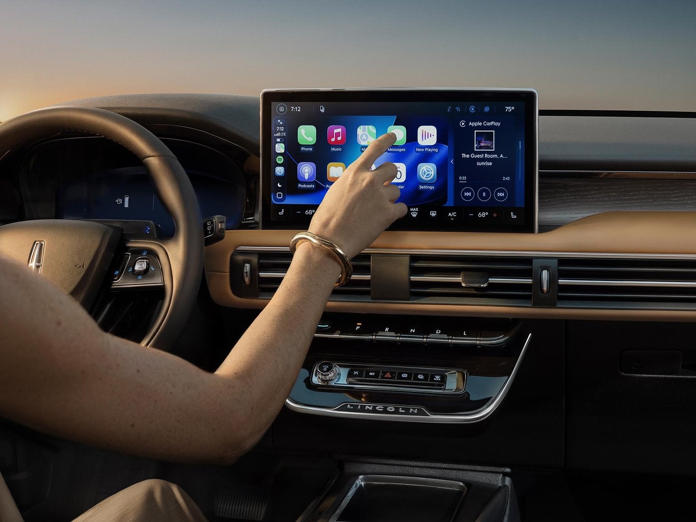 Hand tapping the center touchscreen inside a Lincoln Corsair