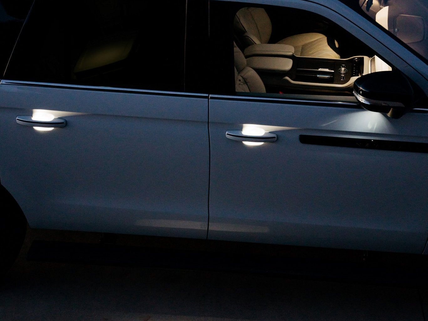 Close view of the side doors of a Lincoln Navigator Black Label at night