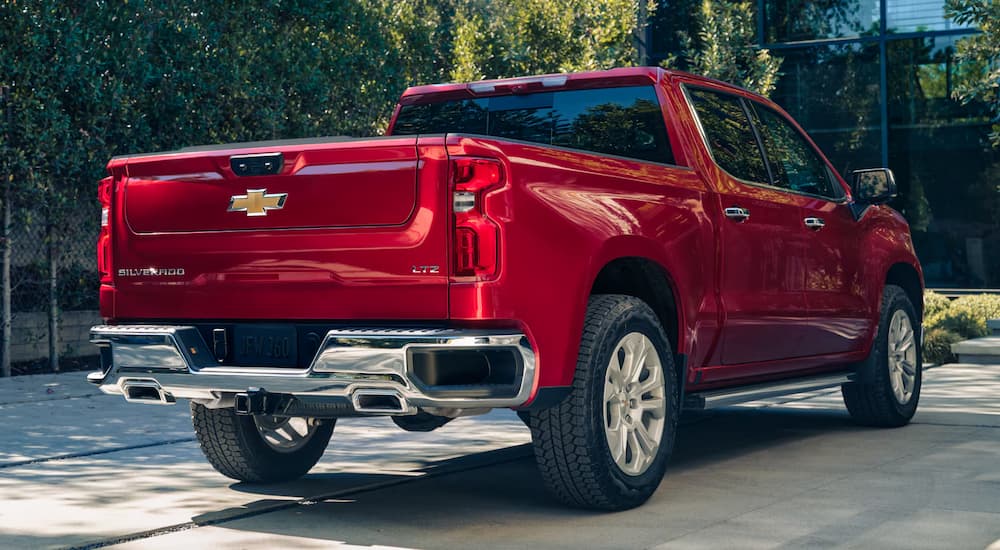 A red 2025 Chevy Silverado 1500 LTZ is parked in a driveway.