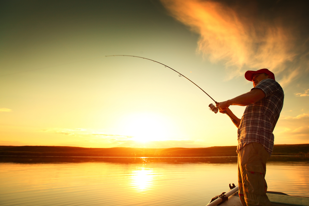 man fishing during sunset