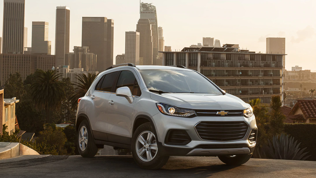 2020 silver chevy trax with city skyline in the background