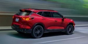 Rear profile view of a red 2021 Chevy Blazer being driven on the highway. | Chevrolet Dealer in Macedon, NY