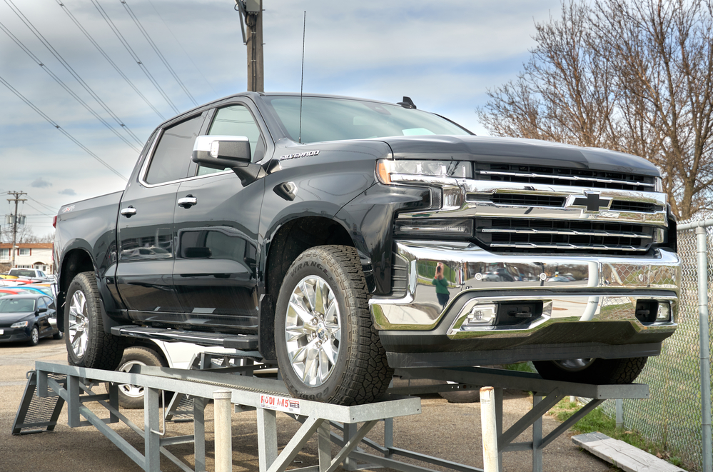 black chevy silverado on a pedastle, front right angle view