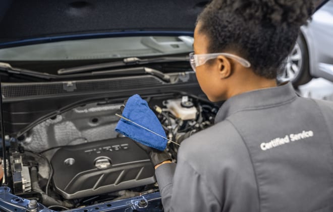 GMC service tech checking oil levels