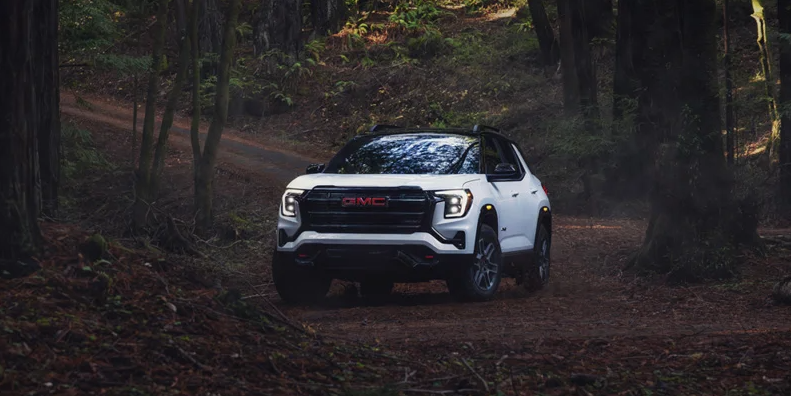 a 2026 GMC terrain driving down a dirt road.