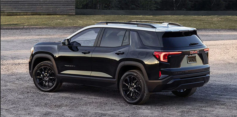 A black 2025 GMC Terrain parked on a sandy parking lot. 