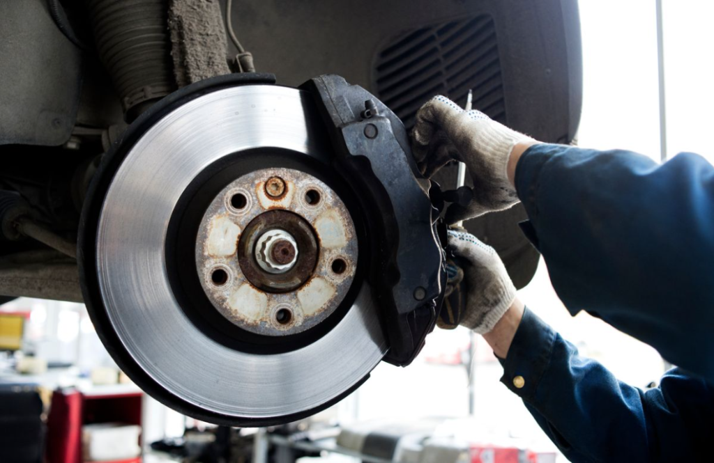 A Photo of brake pads and a car.