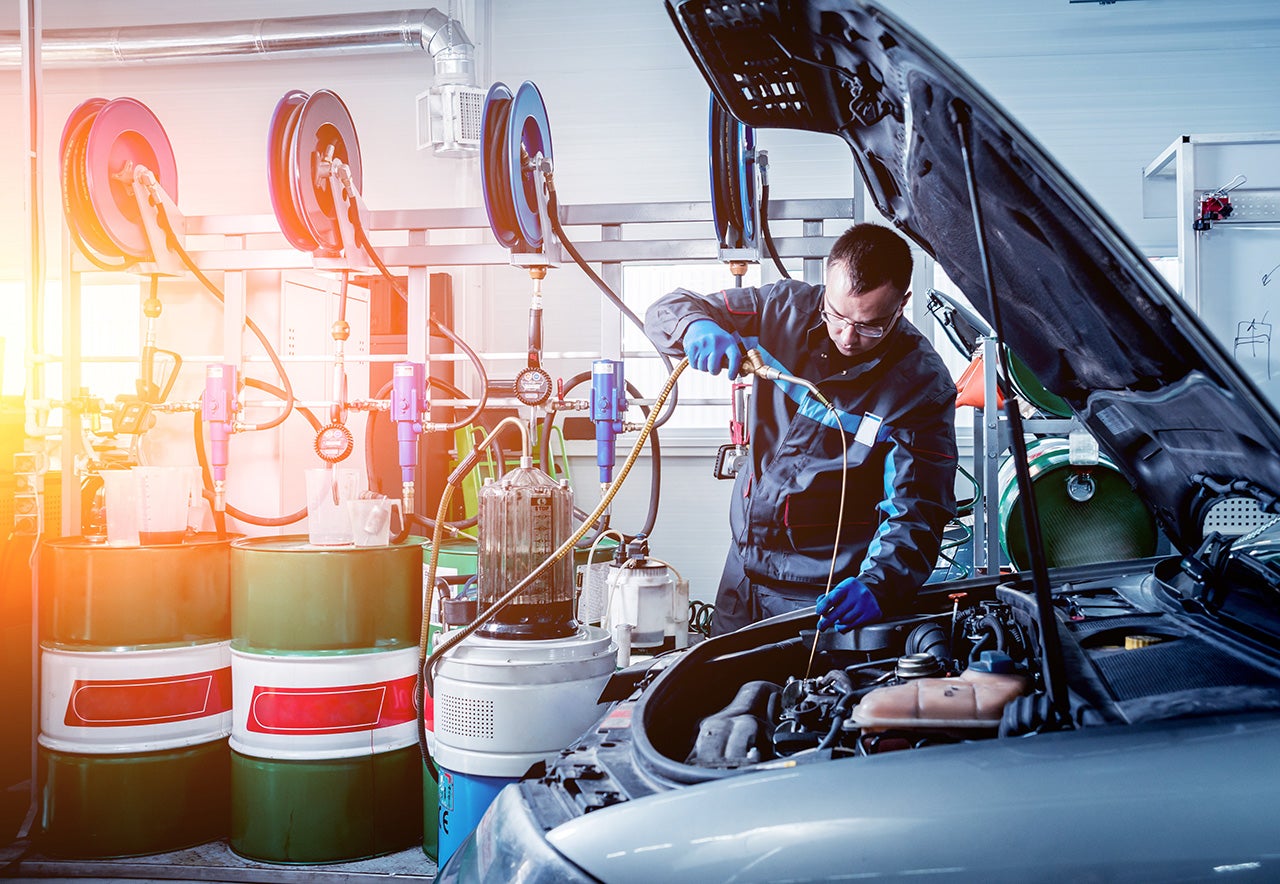 Chevrolet service technician changing oil