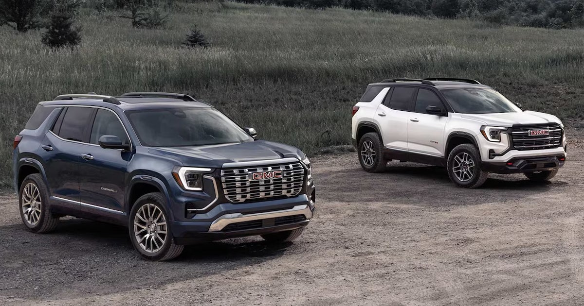Two GMC Terrains parked beside each other on a dirt path.