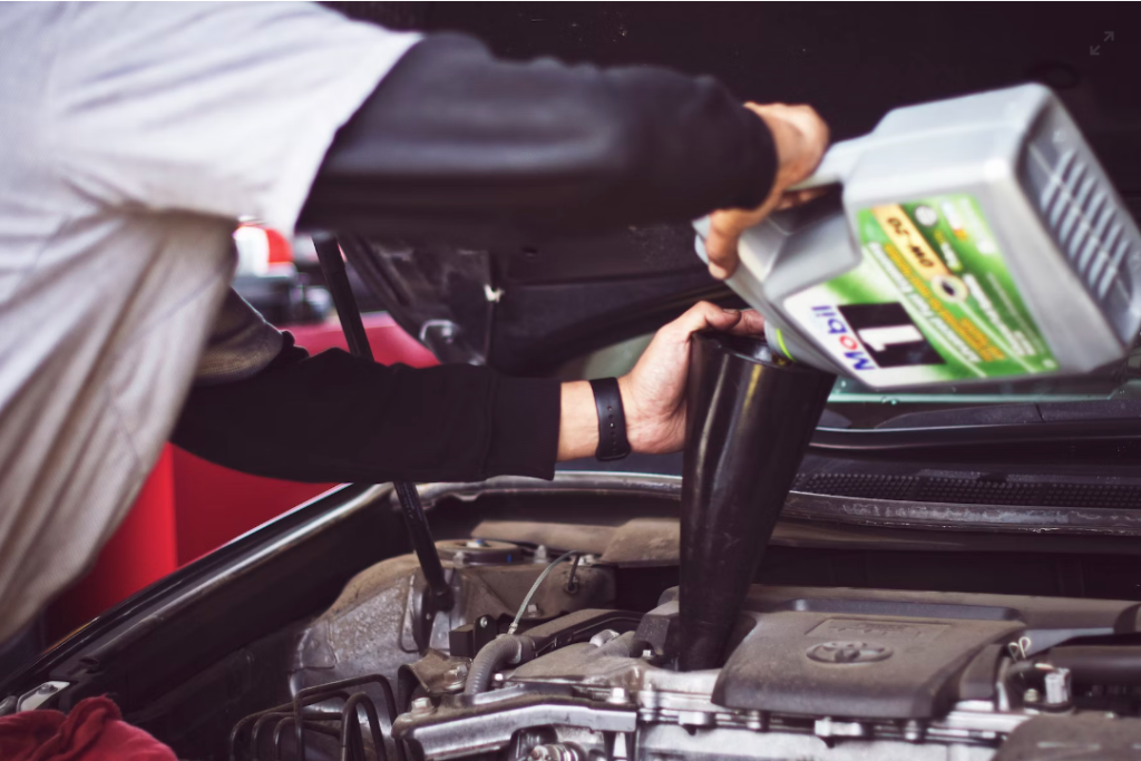 A service tech performs an oil change.