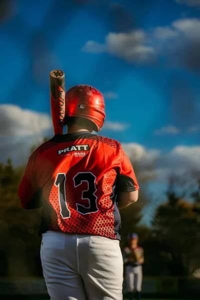 Player in red jersey with number 13 celebrating a play.