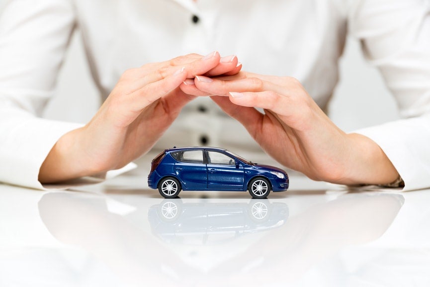 Person covering a car with their hands