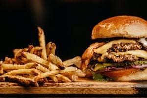 A platter of fries and a double cheeseburger.