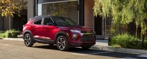 Red Chevrolet Trailblazer parked on the side of a street.