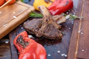 Close-up of grilled meat, red pepper and other vegetables.