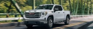 White GMC Sierra pickup on a road.