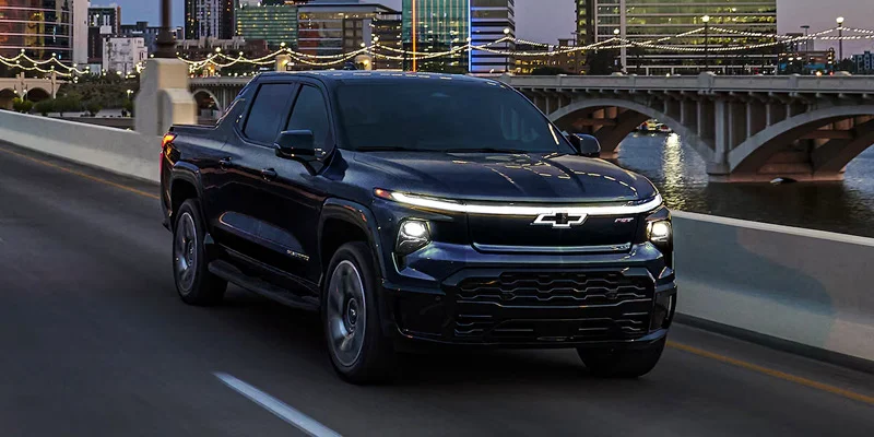 A 2025 Chevrolet Silverado EV driving through a city near Parsons, Kansas