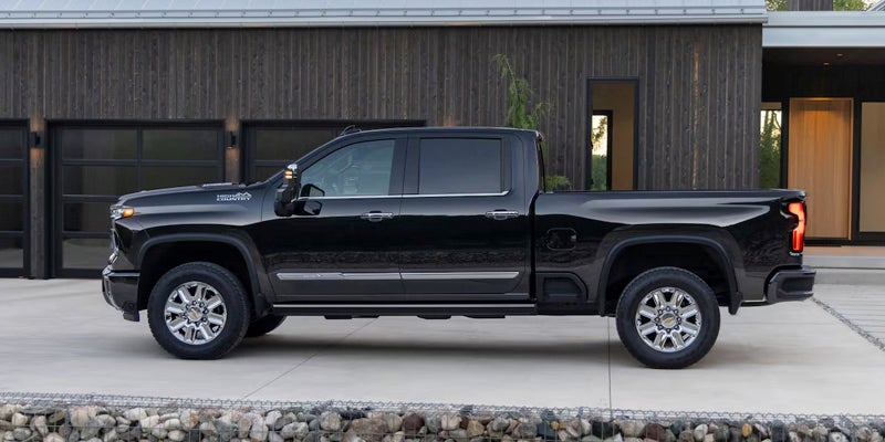 Black 2025 Chevrolet Silverado 2500 in front of Black Garage
