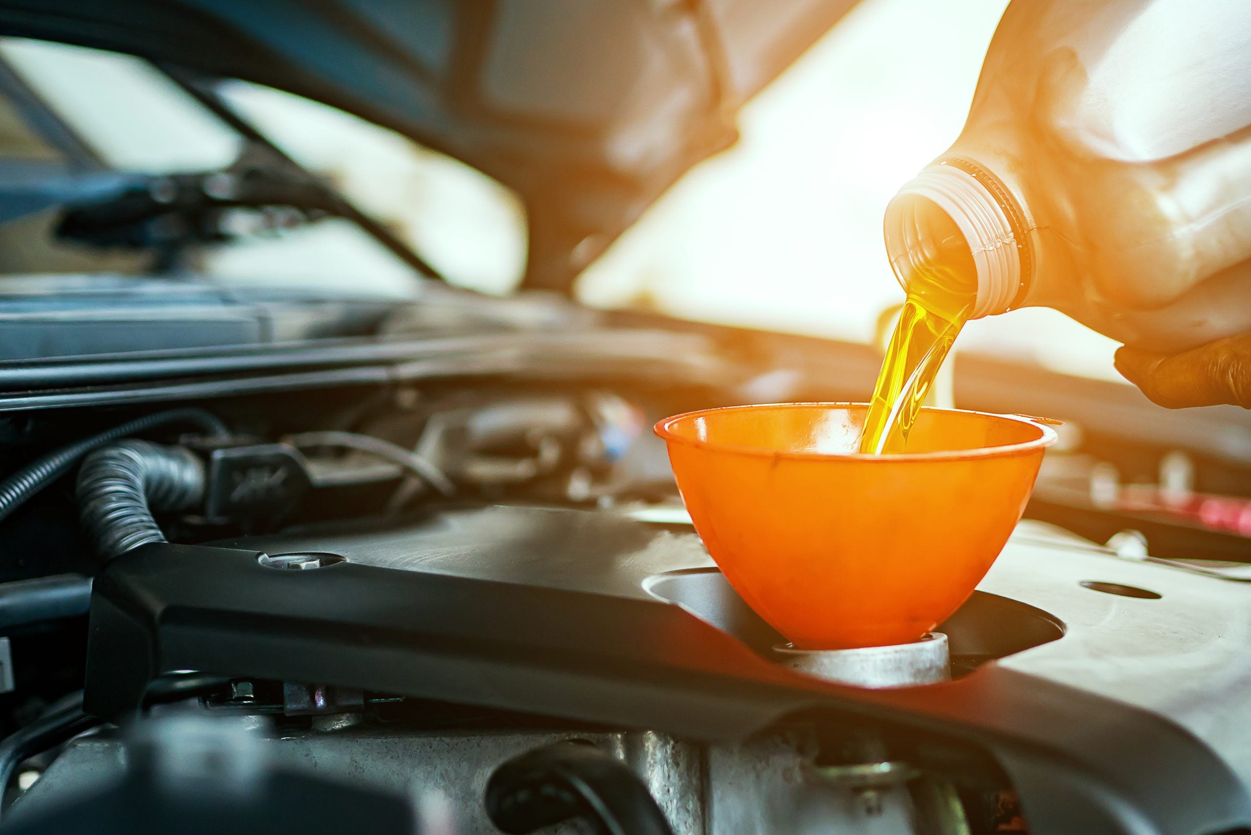 Engine Oil Poured into Funnel