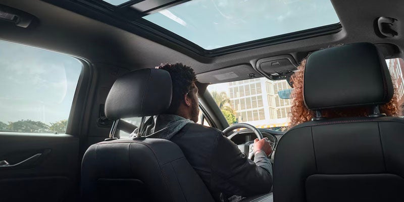 a man and women sitting in the front seat of a 2025 Chevrolet Blazer.