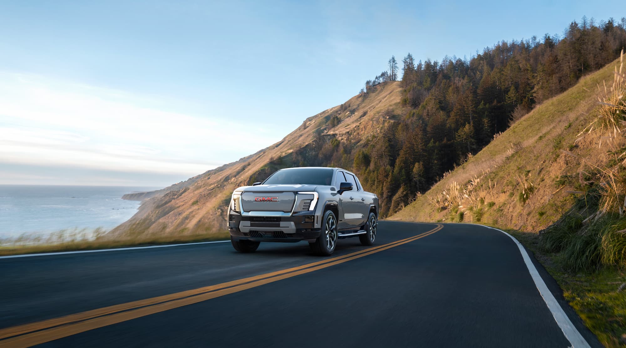 GMC Sierra EV driving on a coastal road