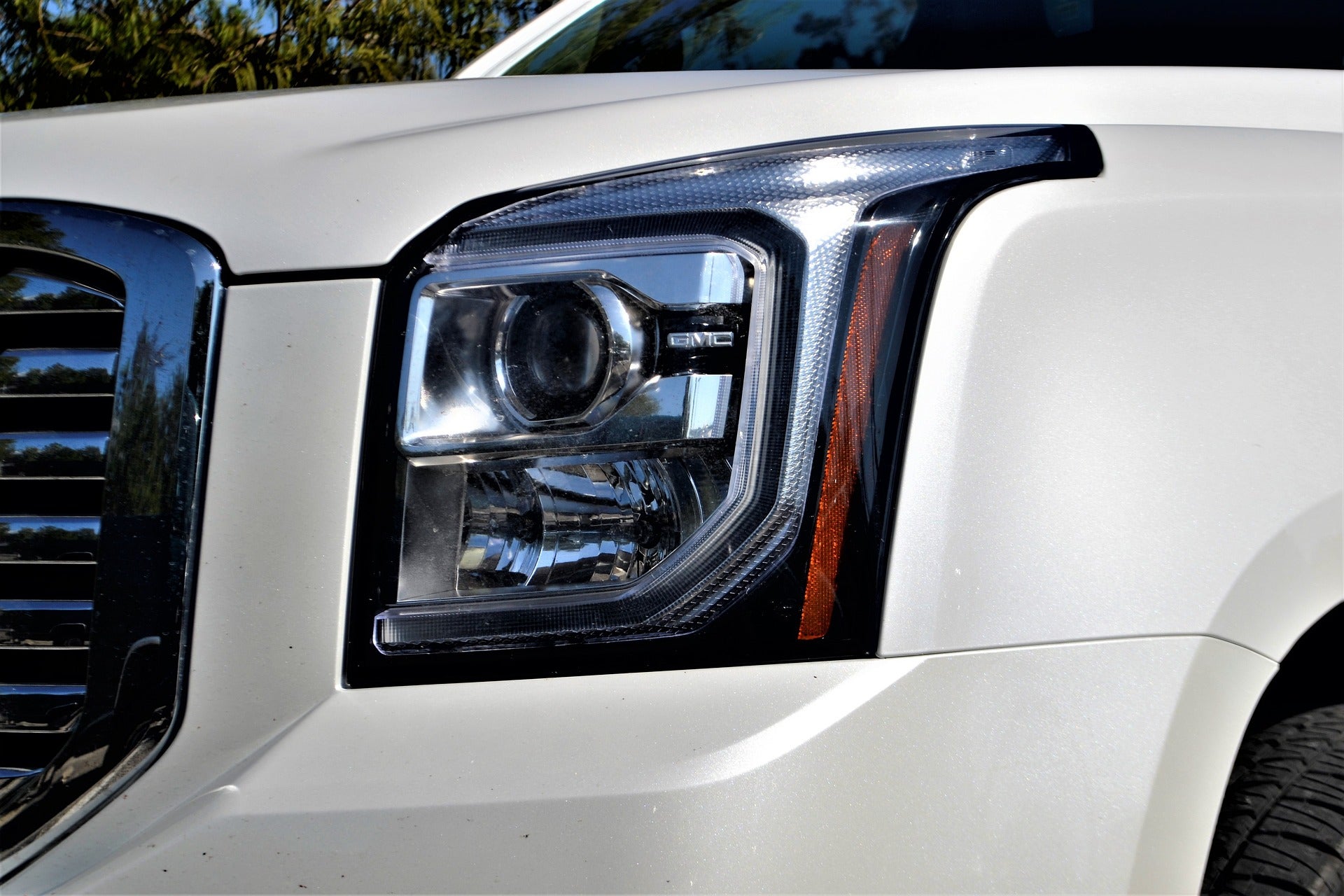 The headlight of a GMC Yukon
