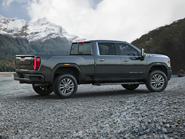 A GMC Sierra 2500 parked outside by mountains