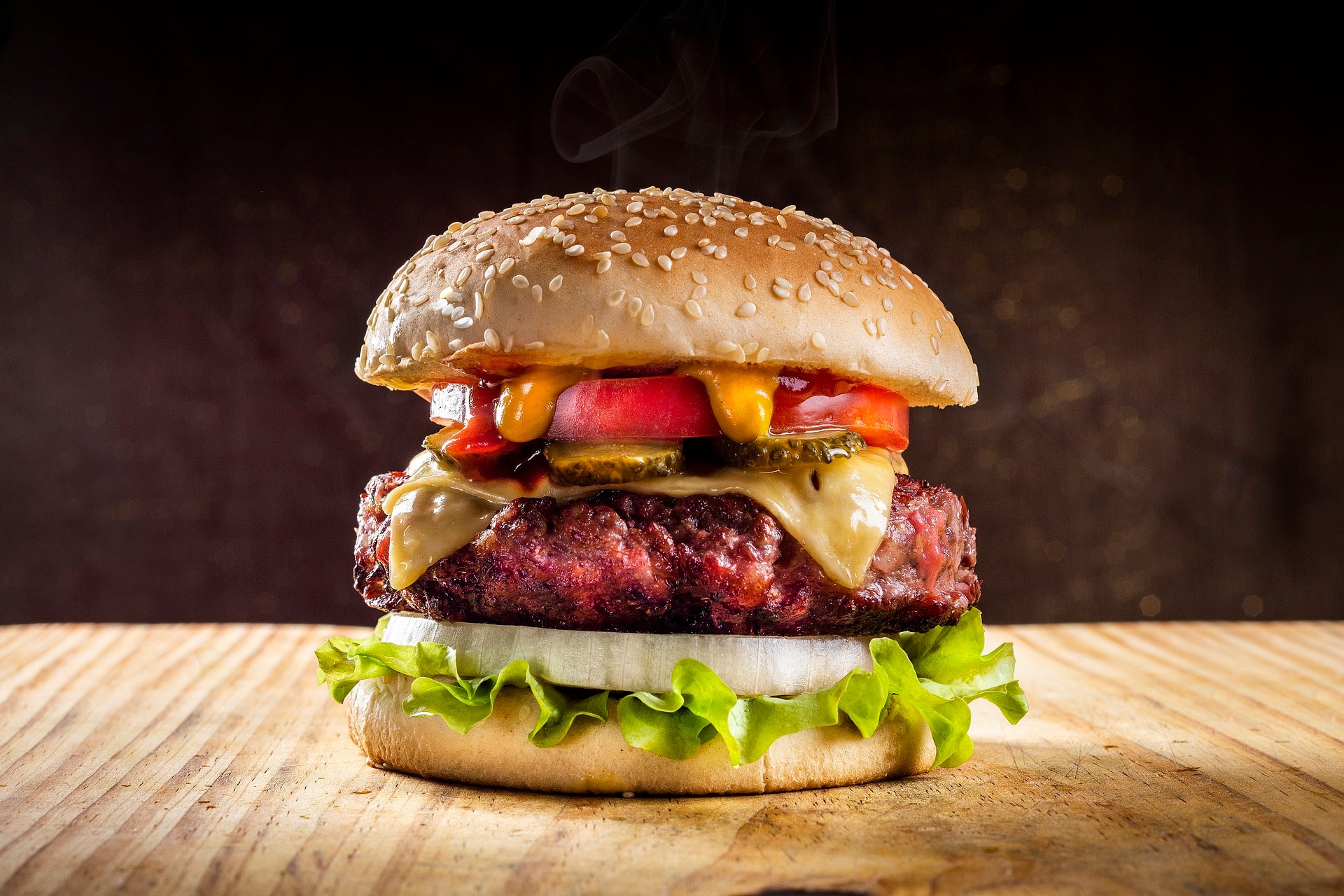 A hamburger on a wooden table