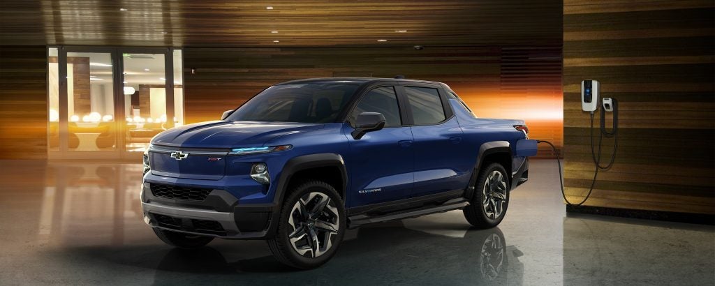 Blue Chevrolet Silverado EV charging at indoor station