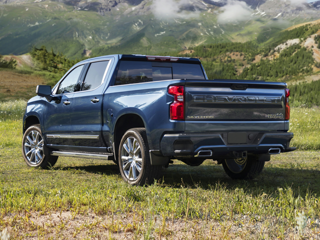 A blue truck parked in the grass