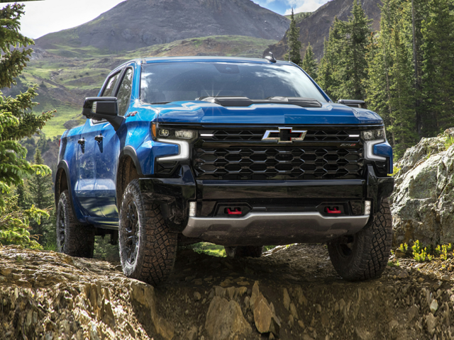 A blue Silverado 1500 driving outside