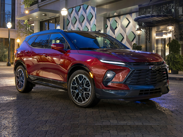 A red Chevy Blazer parked outside at night time