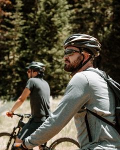 A man and a woman riding bikes