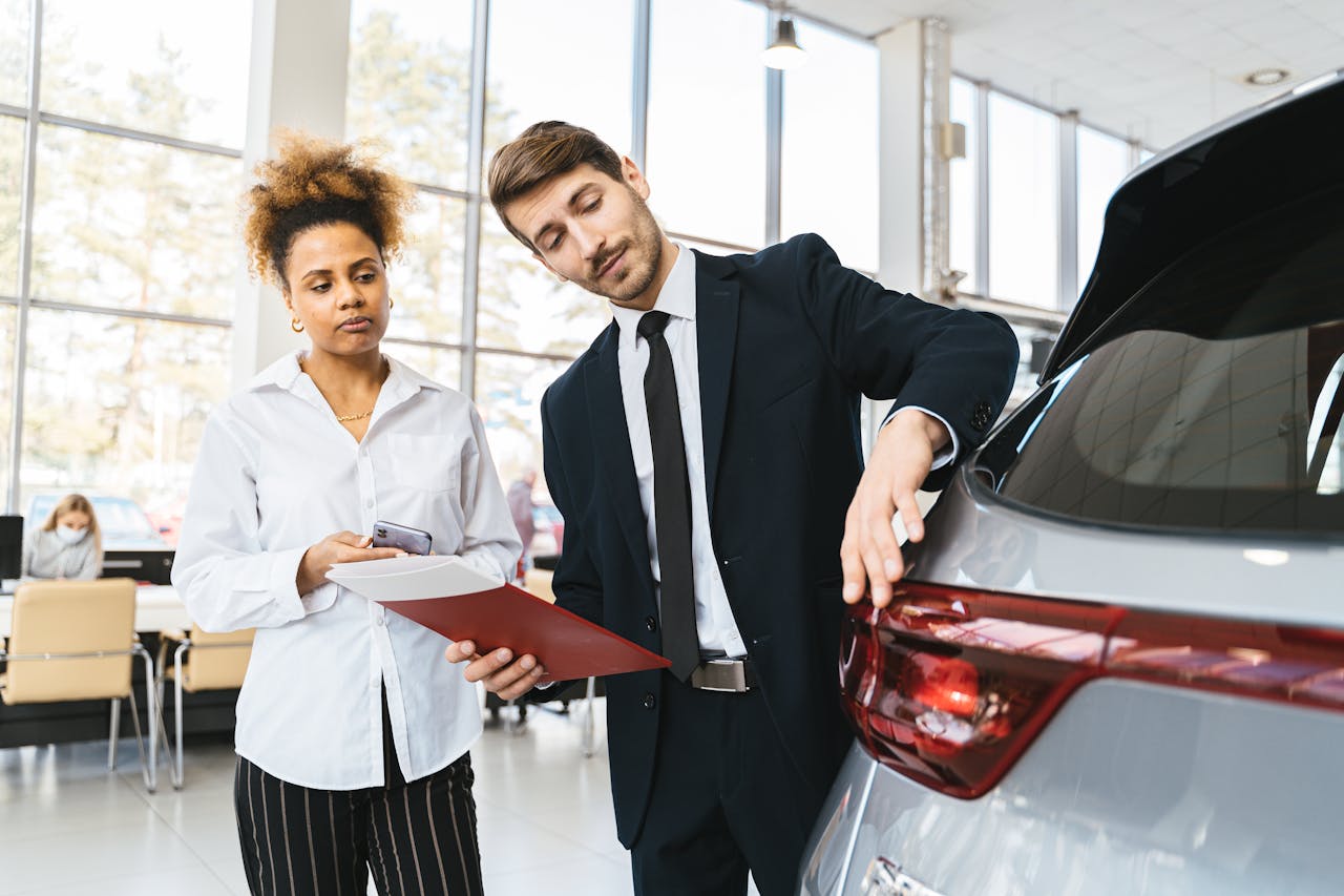 Car salesman talking to a customer about a used vehicle