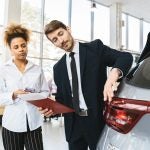 Car salesman talking to a customer about a used vehicle