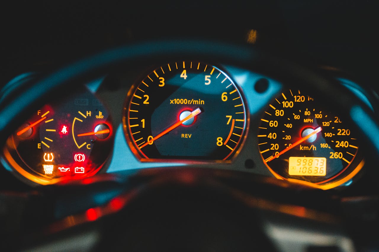 Brake light on the dashboard behind the steering wheel of a car