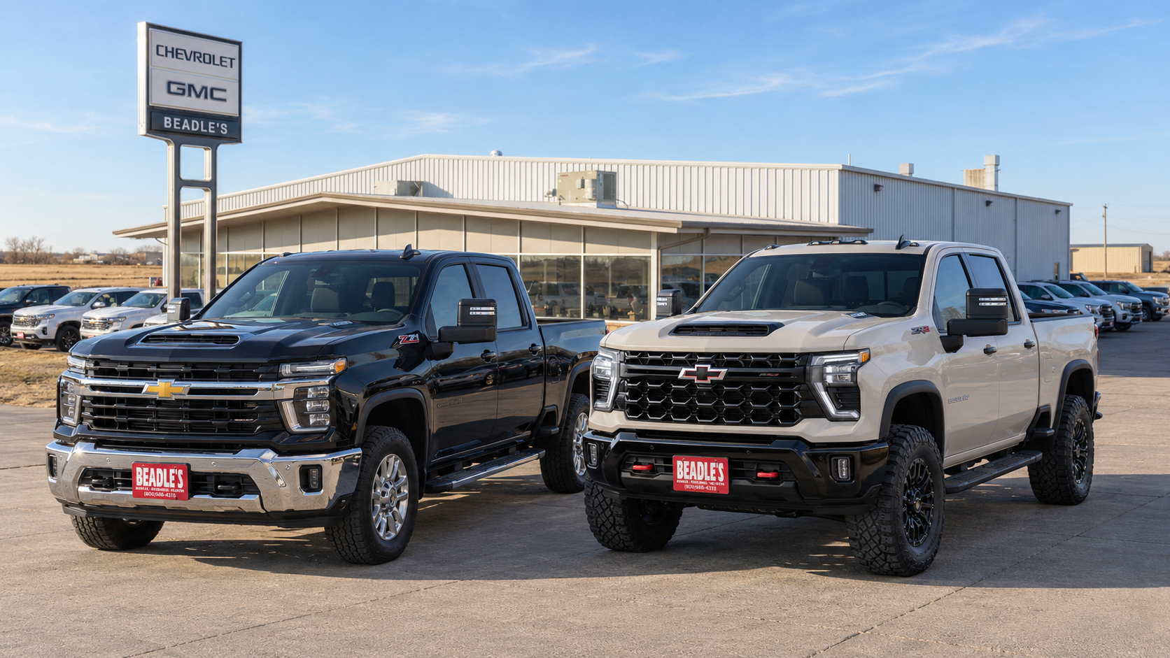 Black Chevrolet Silverado 2500 HD LT with the Z71 package parked beside a lifted White Sands ZR2 at Beadle Chevrolet GMC in Mobridge