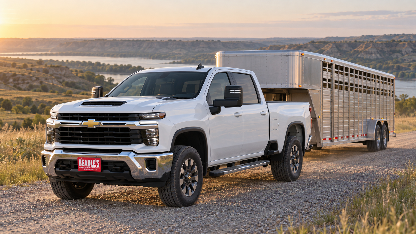 Chevrolet Silverado 3500 HD LT single rear wheel pulling a gooseneck stock trailer on a gravel road in the Missouri River breaks near Mobridge