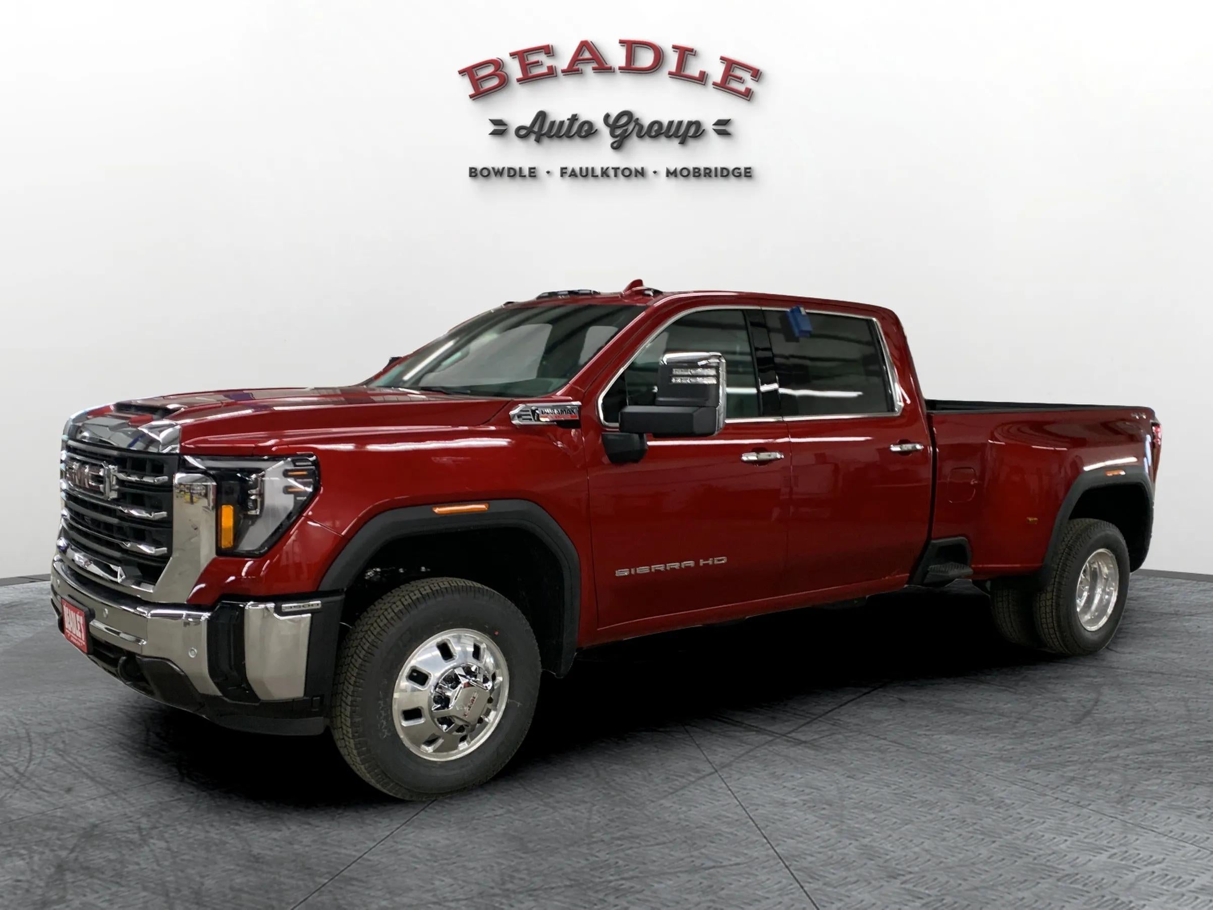 2026 GMC Sierra 3500 HD SLT dually in Volcanic Red Tintcoat, front three-quarter view, at Beadle Chevrolet GMC in Mobridge