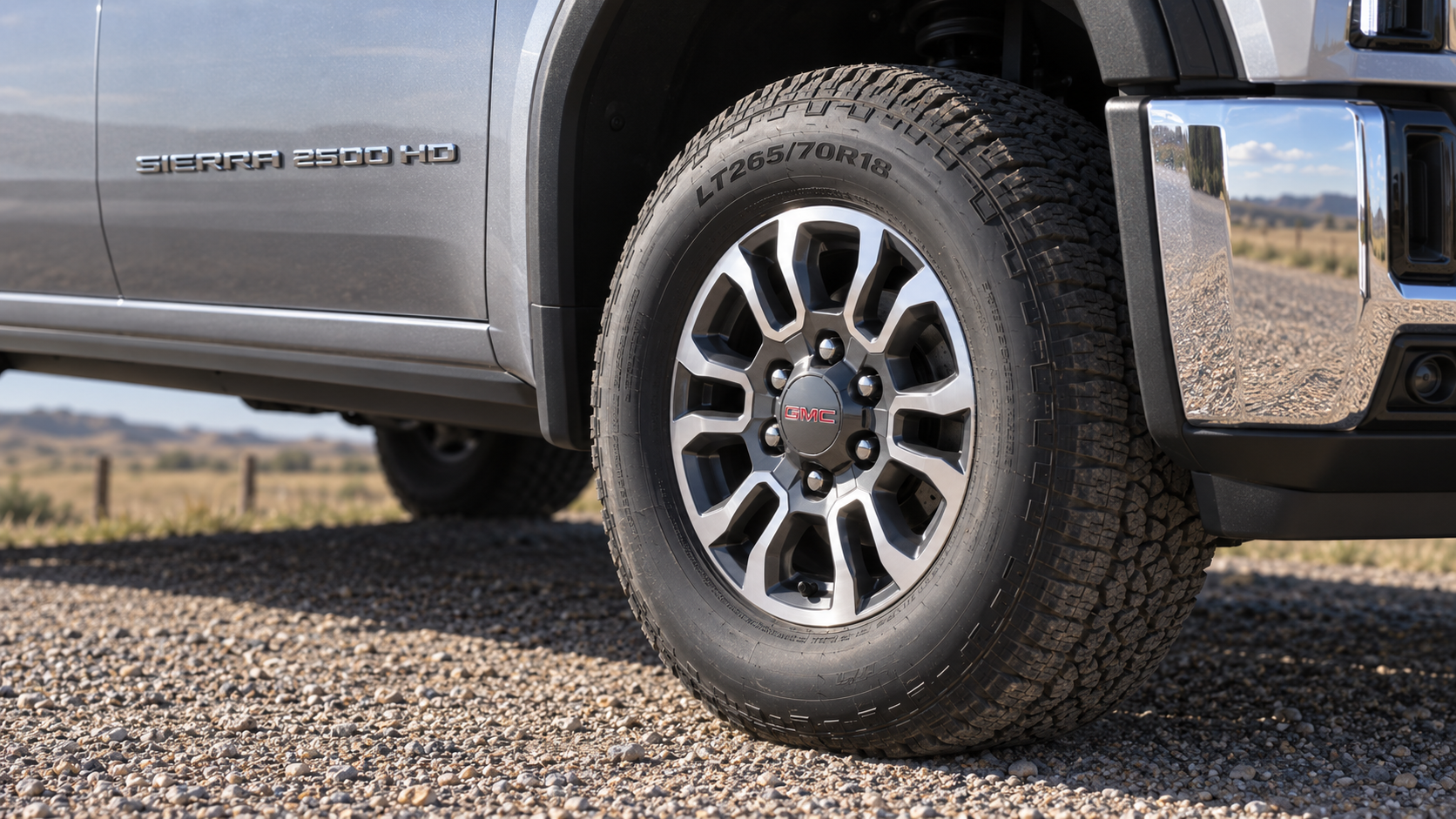 Close-up of the 18-inch machined aluminum wheel with dark grey pockets on a 2027 GMC Sierra 2500 HD at Beadle Chevrolet GMC in Mobridge